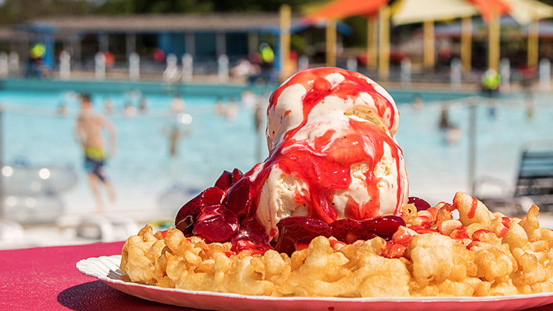 Funnel Cake with strawberries and whipped cream by the pool